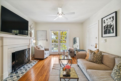 A living room with a fireplace and a television.