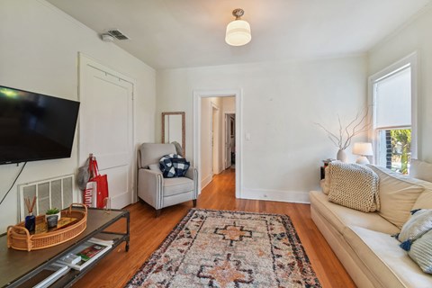 a living room with a couch and a chair and a tv
