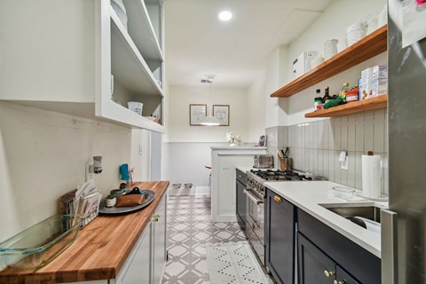 a kitchen with a counter top and a stove and a sink