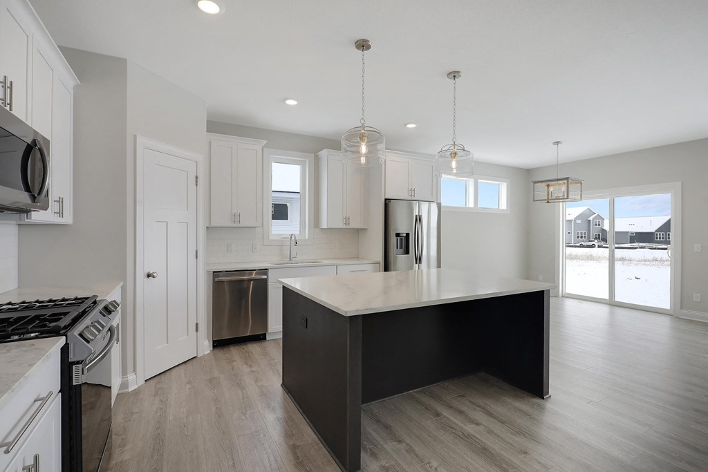 a large kitchen with an island in the middle of it