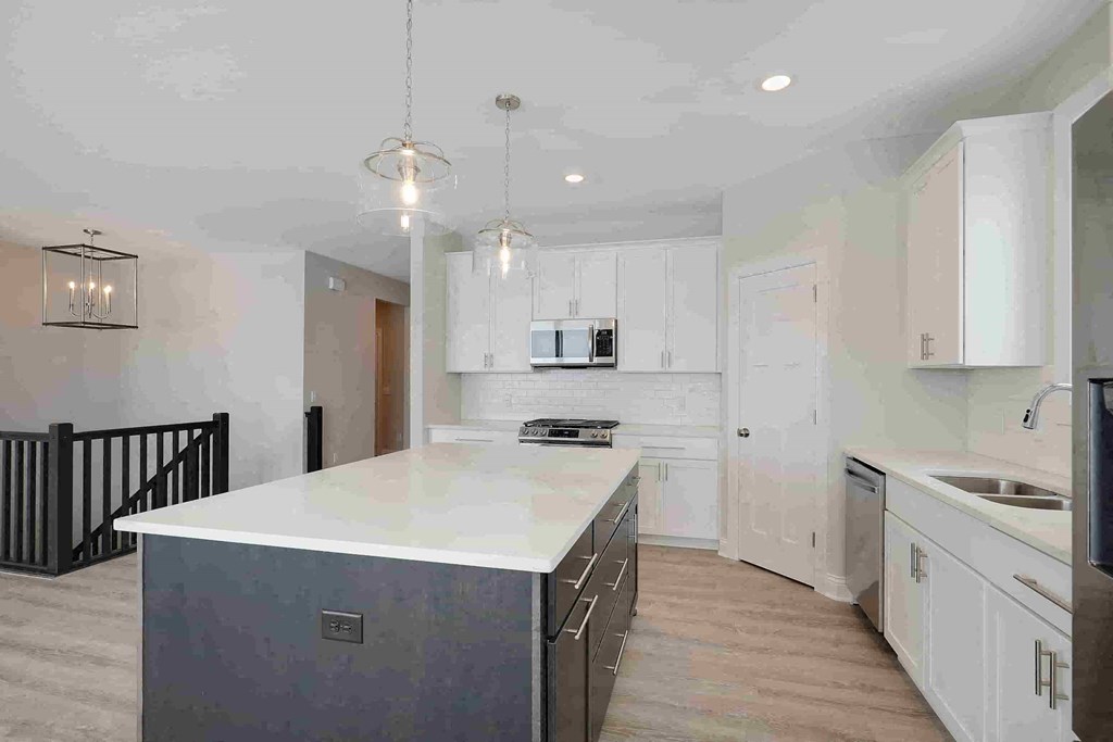 a large kitchen with an island in the middle