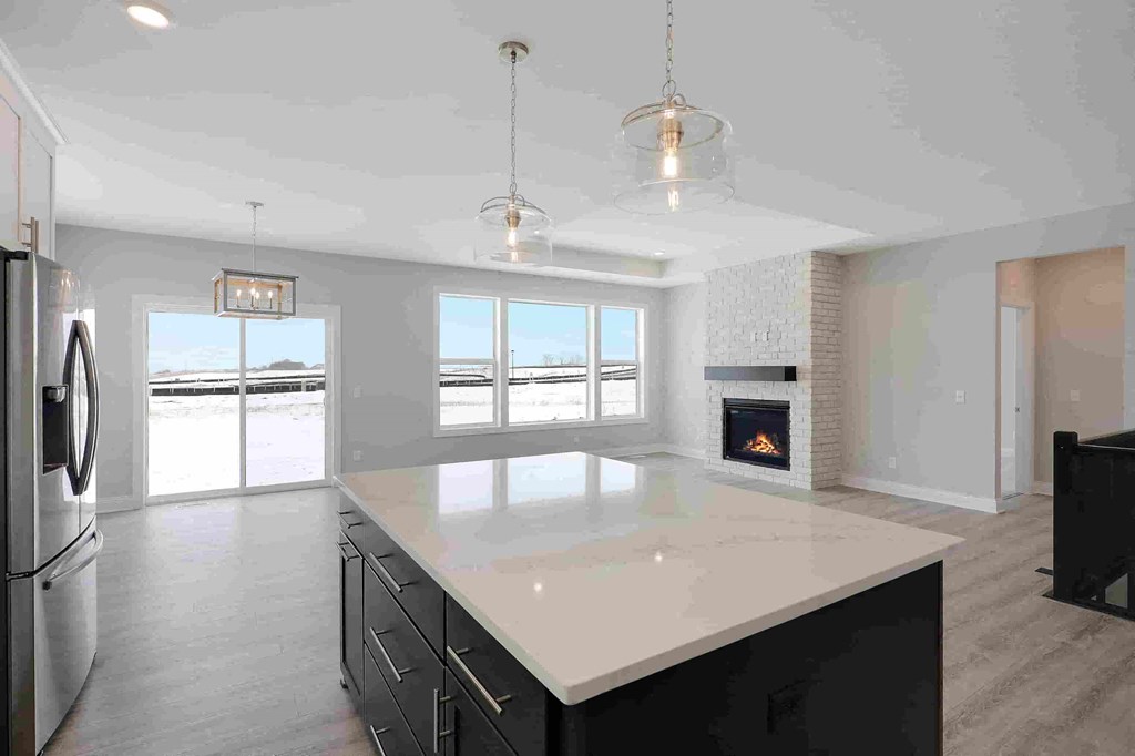 a kitchen with a large island and a fireplace