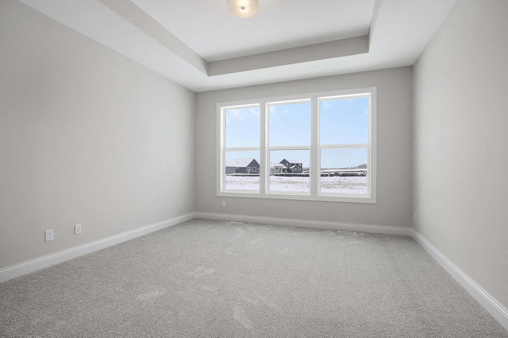 an empty room with a view of a building out the window