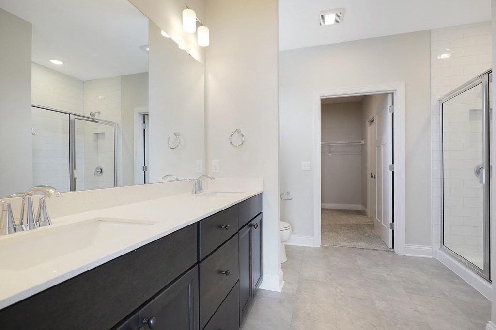 a bathroom with a sink and a shower and a toilet