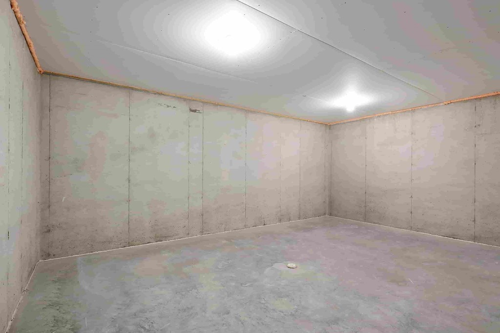 a room with white walls and a concrete floor