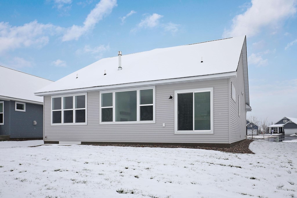 the front of the house with snow on the ground