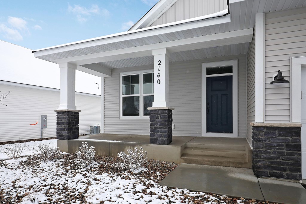 the front of a house with snow on the ground