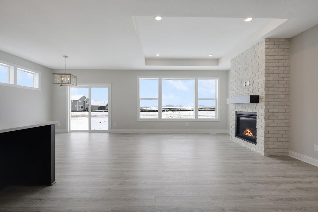 a living room with a fireplace and a large window