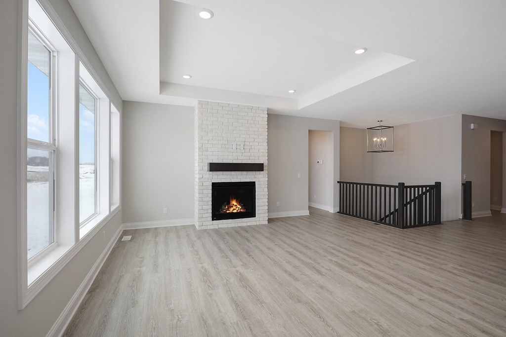 a living room with a fireplace and a wooden floor
