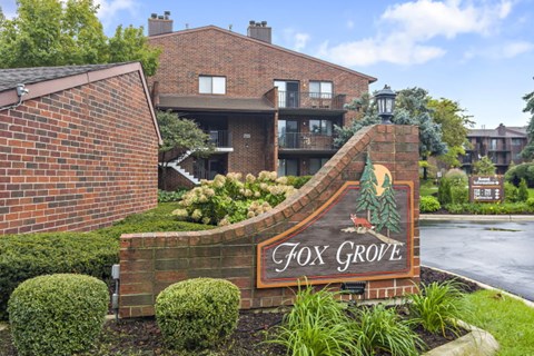 A sign for Fox Grove is in front of a building.