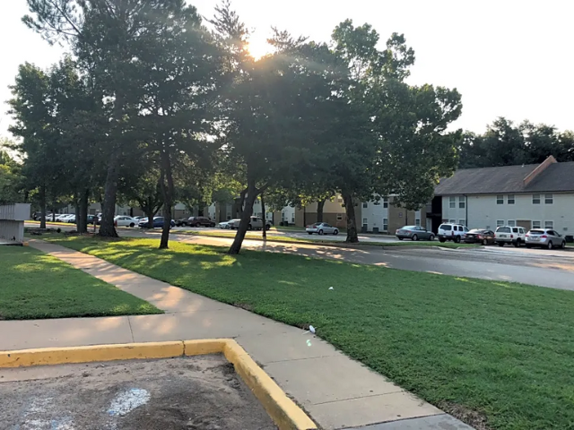 a city street with trees and houses on it