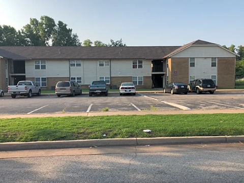 a parking lot with cars in front of a building