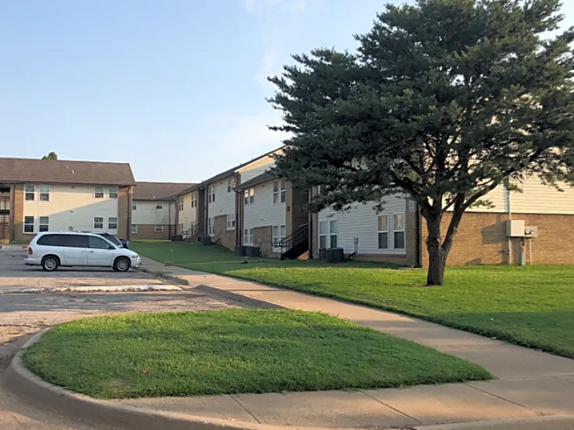 a white van parked in front of an apartment building