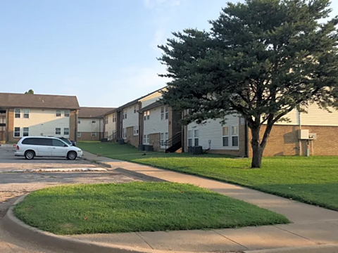 a white van parked in front of an apartment building
