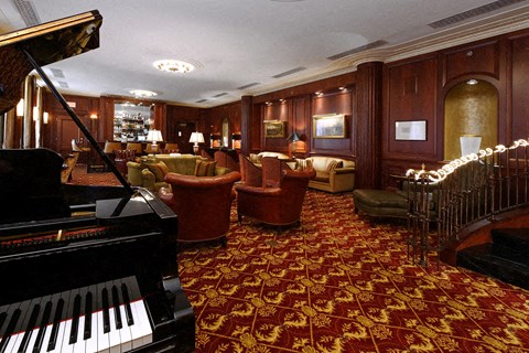 a living room filled with furniture and a piano