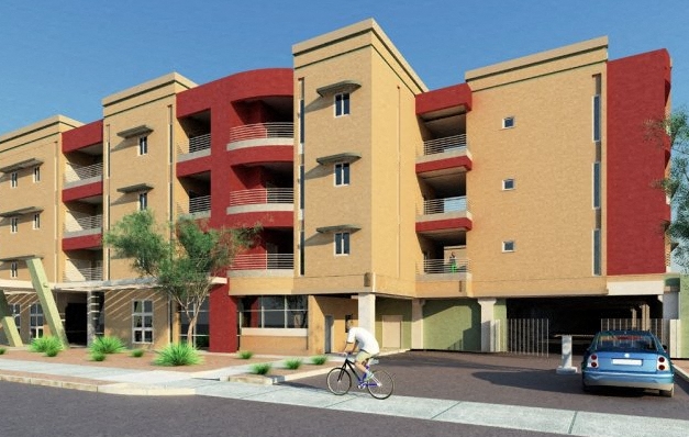 a person riding a bike in front of an apartment building