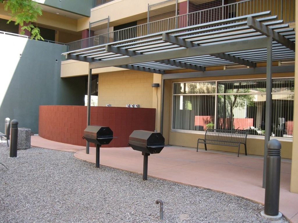 a building with two smoker pits in front of it