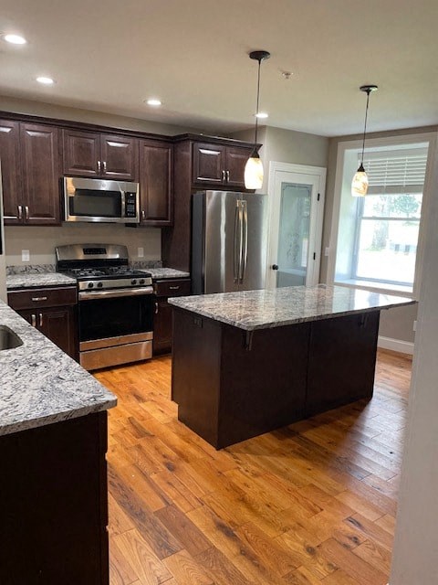 a kitchen with an island and stainless steel appliances