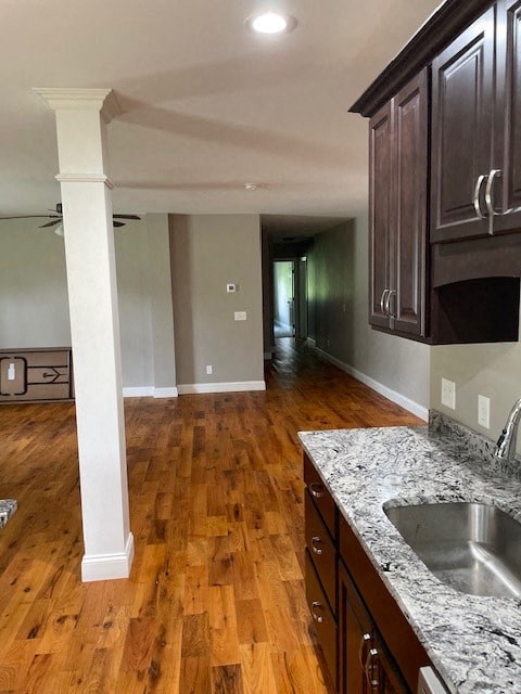 a kitchen with a sink and wooden floors