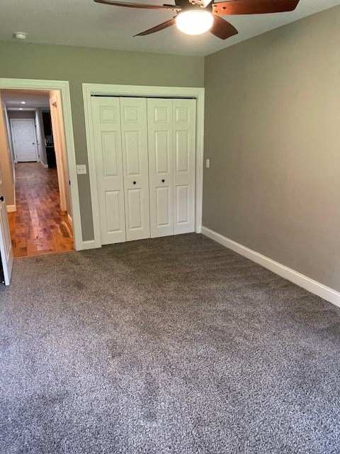 an empty living room with carpet and a ceiling fan