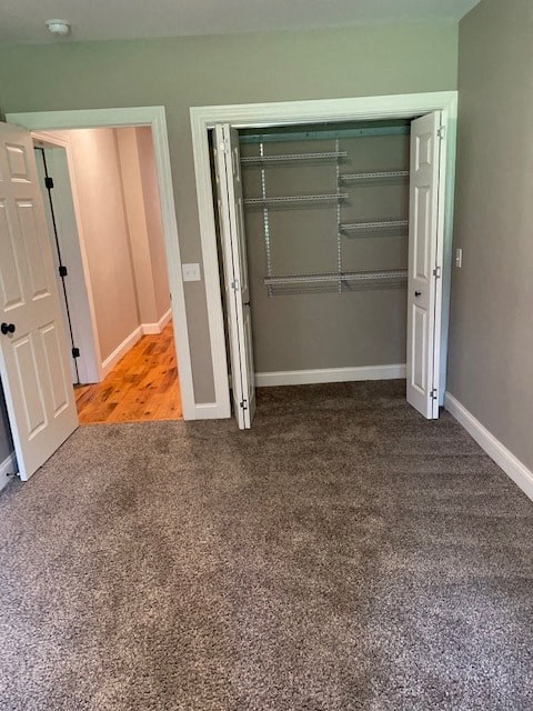 a room with an empty closet and a carpeted floor