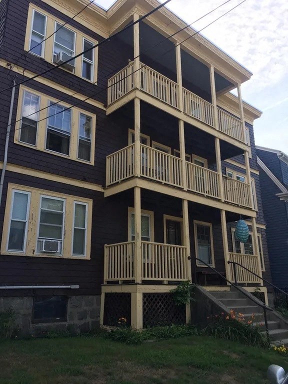A two-story building with a balcony on the second floor.