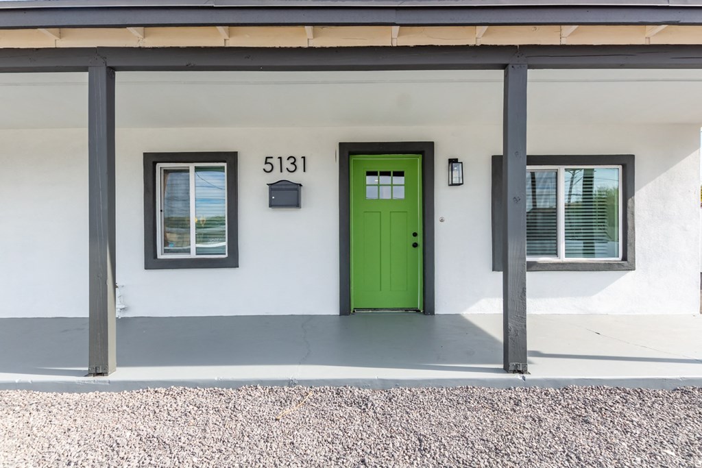 the outside of a building with a green door