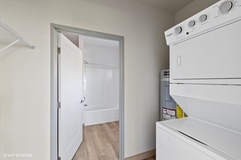 A white oven is in a kitchen with a white door.