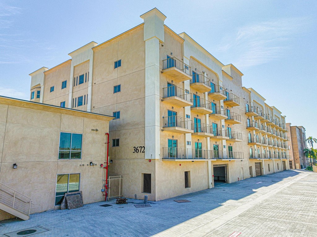 a building with many balconies and a street in front of it