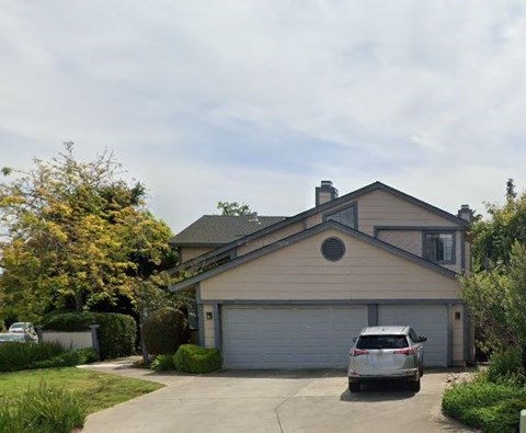 a house with a car parked in the driveway
