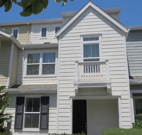 a white house with a balcony on the front