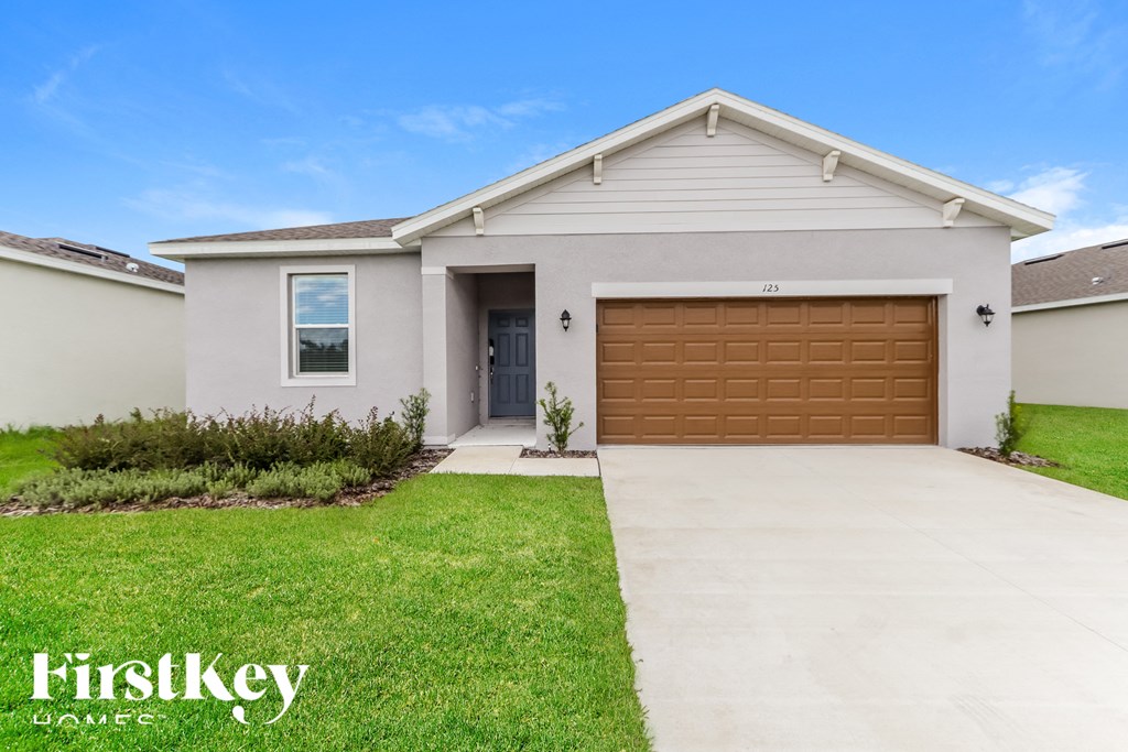 a white house with a brown garage door