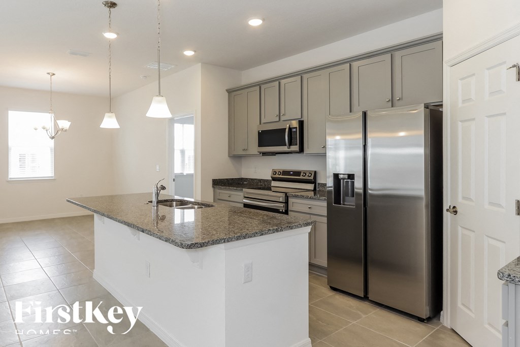 a kitchen with stainless steel appliances and a granite counter top