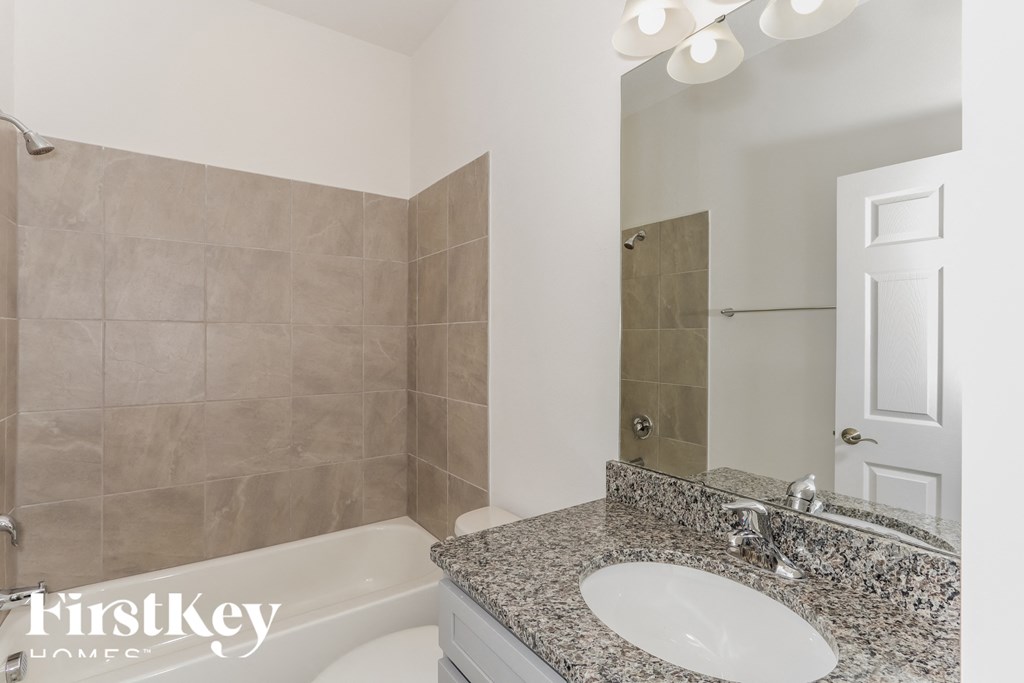 a bathroom with a sink and a shower and a toilet