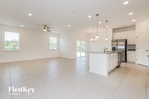 a large kitchen with white cabinets and a white counter top