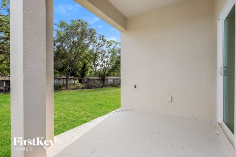 the backyard of a house with grass and a yard