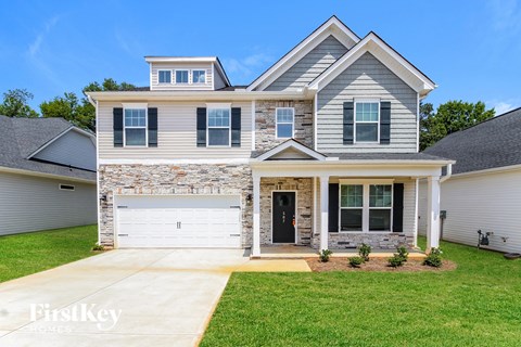 A two-story house with a garage is for sale.