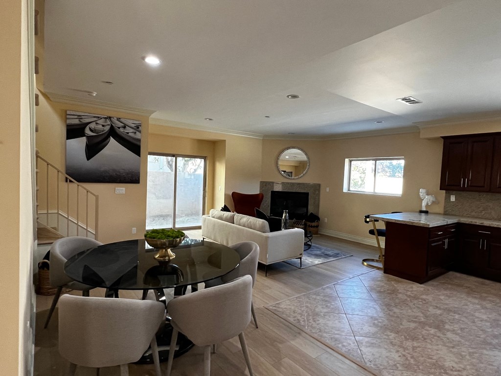 a dining room and living room with a table and chairs