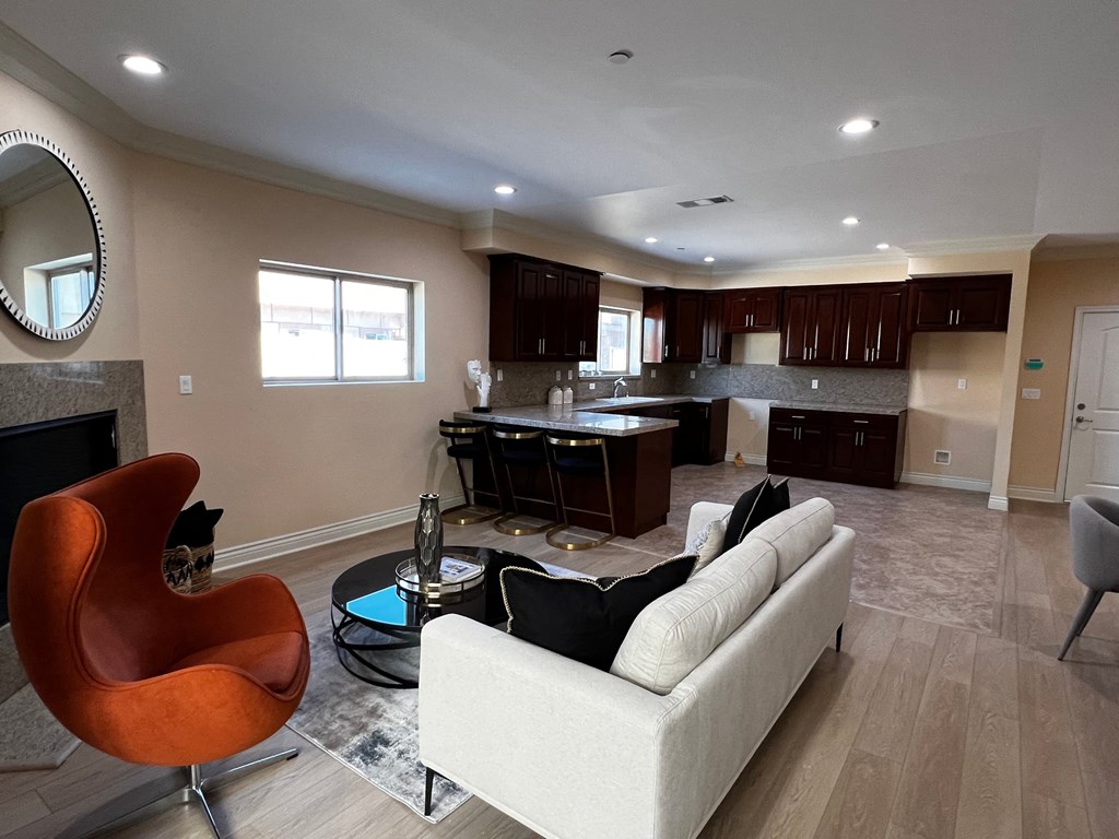 a living room and kitchen with a couch and a table
