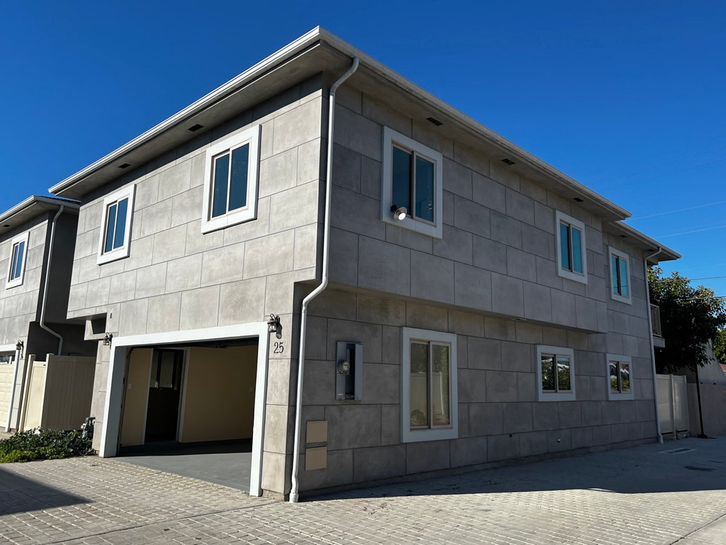 a large gray building with an open garage