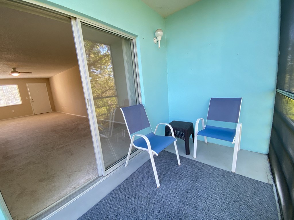 a room with two chairs and a sliding glass door
