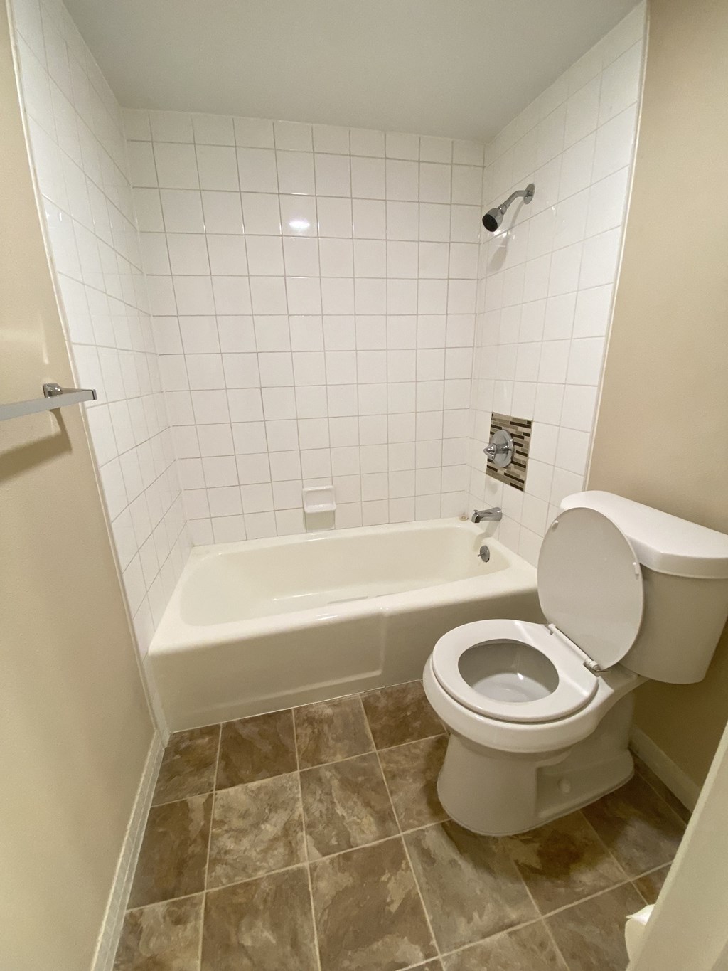 a small bathroom with a toilet and a bath tub