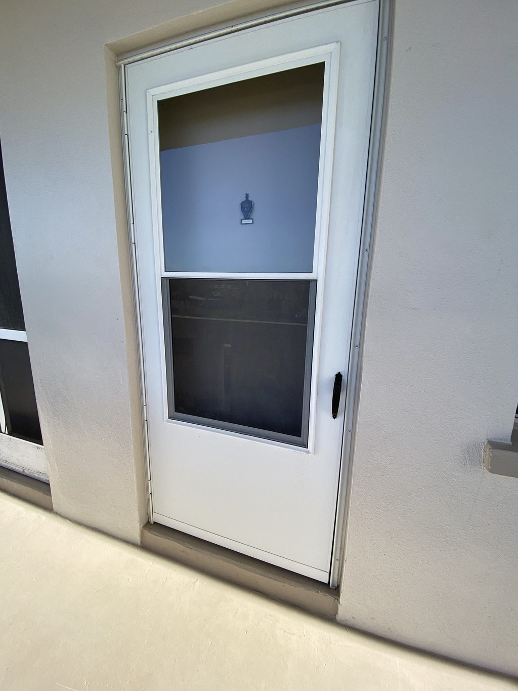 a door with a window on the side of a wall