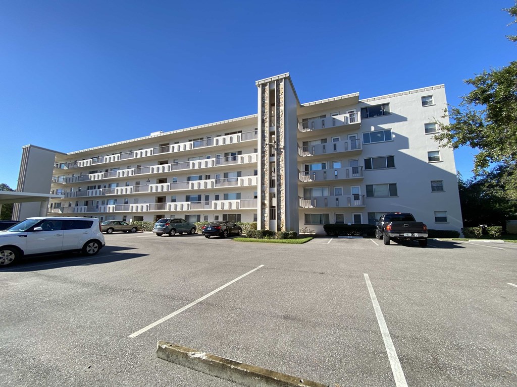 a large parking lot in front of an apartment building