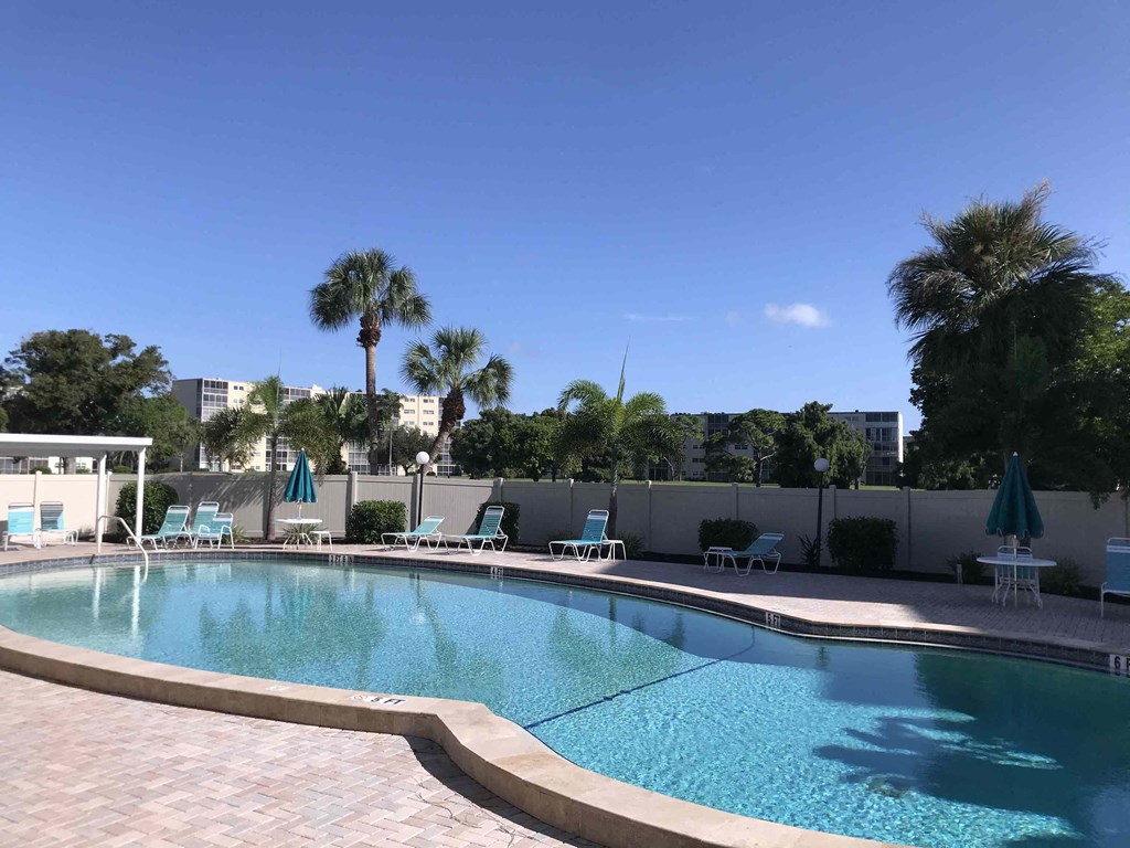 a swimming pool at a resort with palm trees