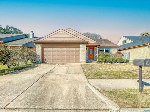 a house with a driveway and a garage door