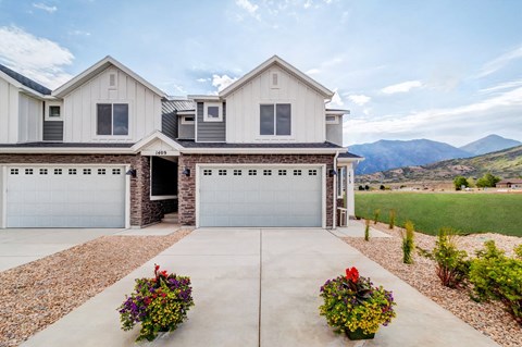the front of a house with a garage and a driveway