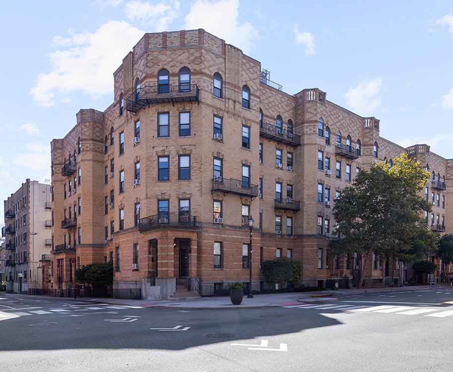 A large red brick building with many windows and balconies.