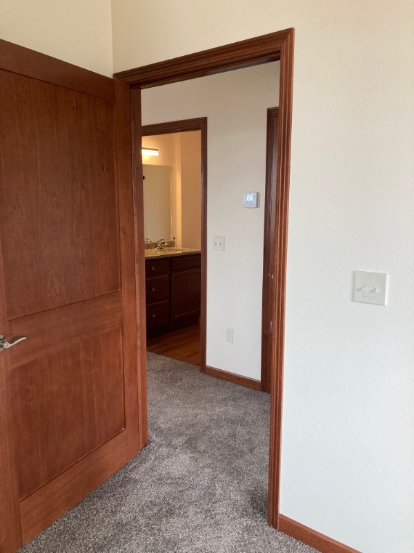 the door to the master bedroom is open to the bathroom