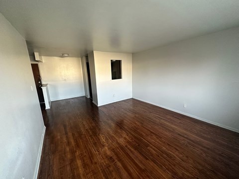 A room with wooden floors and white walls.